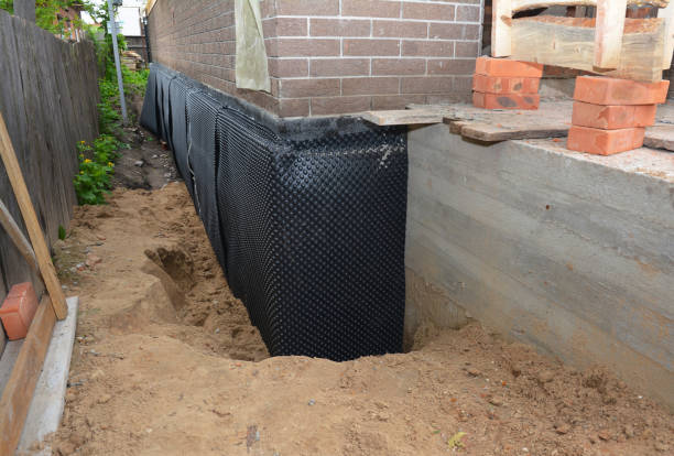 Happy homeowners after waterproofing job in Foster